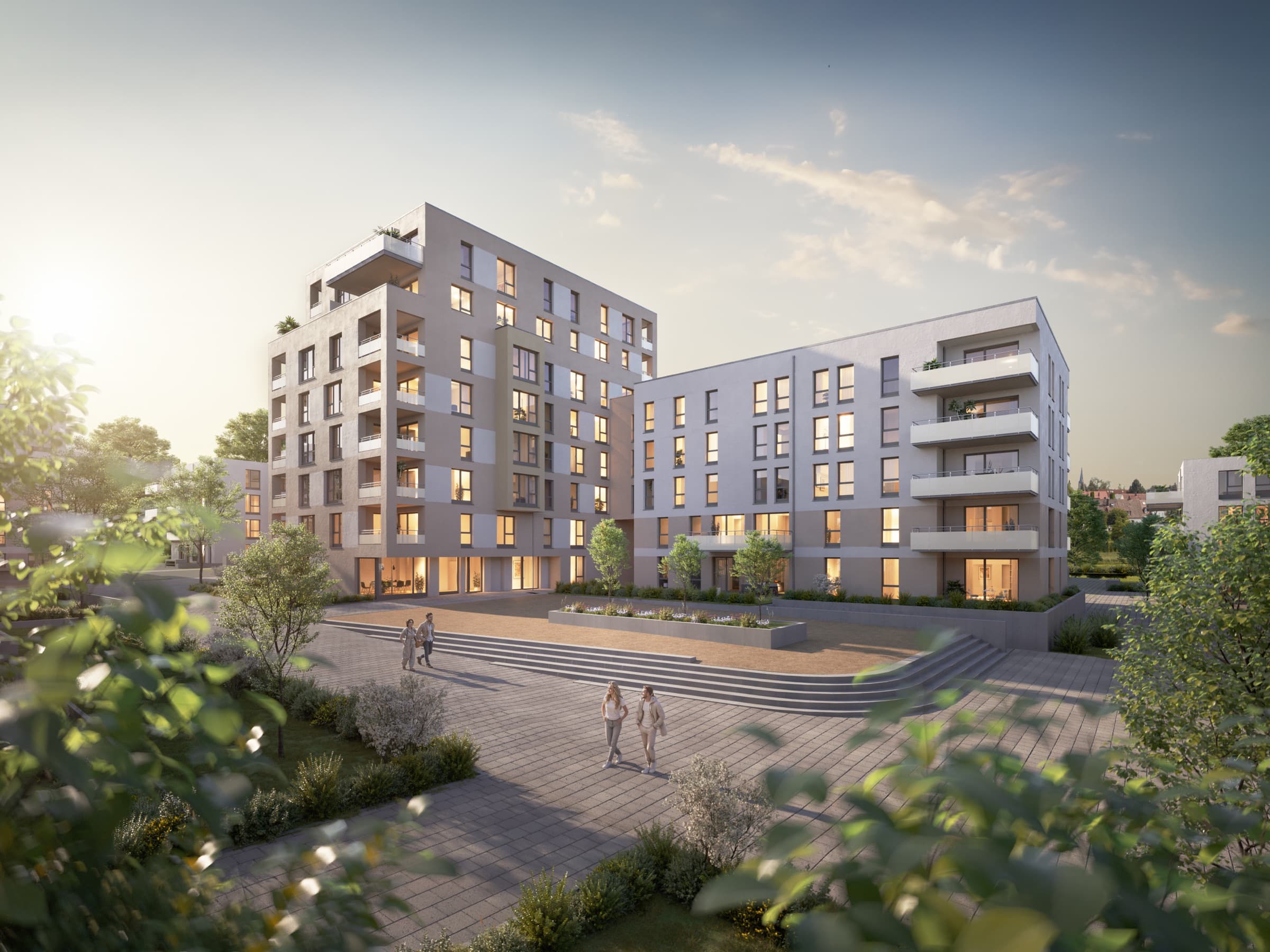 Neubauquartier mit Platz und Wohntürmen in der Abendsonne